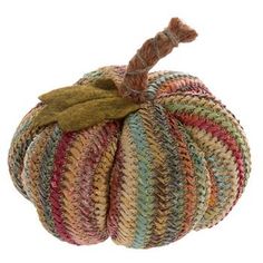 a multicolored pumpkin hanging from a rope