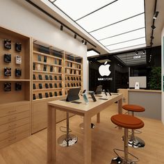 an apple store with several stools in front of the counter