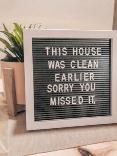 a sign that reads this house was clean earlier sorry you missed it next to a potted plant