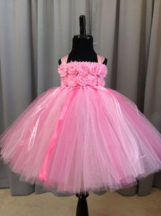 Fuzzy Duckling Design dresses ~ handcrafted for the little princess in your life. Our beautiful flower girl dresses feature a stretchy, crocheted bodice that is fully lined for both comfort and modesty. These extra full skirts sparkle and shine with four layers of high quality tulle in matte, shimmer, and glitter finishes. Satin ribbons, flowers, and jewels are added to make each dress something special. To determine the length of dress to order: measure from where the top edge of the bodice wil Princess Dresses For Toddlers, Tutu For Baby, Dresses For Toddlers, Pink Flower Girl Dress, Custom Flower Girl Dress, Pink Princess Dress, Toddler Princess Dress, Pink Flower Girl, Baby Birthday Dress