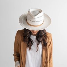 We took our customer favorite Monroe style, and made her into a white straw hat! The Arlo is a teardrop fedora with a slightly curled up brim which is a universally flattering shape. The Arlo features special hand woven venting on the crown and brim, plus a genuine leather multi-strand band and a Gigi Pip bronze pin. Dimensions: The Arlo has a 10.5 cm front of crown height and 8.8 cm brim width. Materials: The Arlo is made of finely pressed paper straw with a genuine leather band and cotton-poly Fedora Women, Packable Sun Hat, Gigi Pip, Womens Straw Hats, Hand Sewn Leather, Straw Fedora Hat, Floppy Sun Hats, Straw Fedora