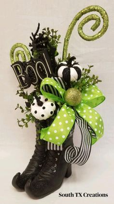 a black boot decorated with green and white decorations