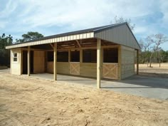 a horse barn with two stalls in the middle