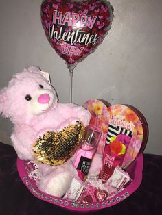 a valentine's day gift basket with a pink teddy bear