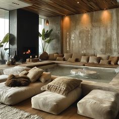 a living room filled with furniture and a fire place in the middle of the room