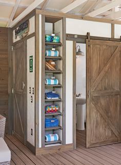 the inside of a storage shed with doors open and shelves full of items in it