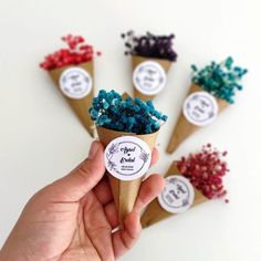 there are six cones with different colored candies in them and one cone is filled with blue, red, green, and purple sprinkles