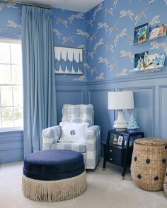 a room with blue walls and white furniture