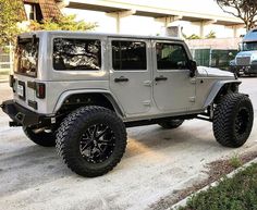 a white jeep parked in front of a building