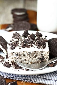 an oreo cookie and cream sheet cake on a white plate with a fork next to it