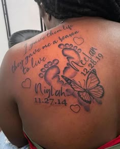 the back of a woman's shoulder with her name and two butterflies on it