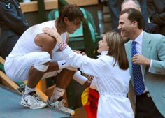 two tennis players are greeting each other on the court with their arms around one another