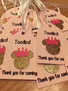 pink and gold minnie mouse birthday tags with princess crowns on them are hanging from a string