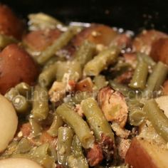 some green beans and potatoes are in a pot