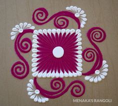 a pink and white design on the floor with swirls in the center, surrounded by flowers