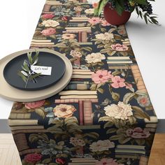 a table runner with books and flowers on it