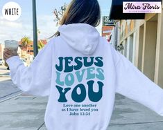 Christian Sweatshirt, Jesus Loves You Hodie, Christian Merch, Christian Sweater, Trendy Christian Tee, Jesus Shirt, Bible Verse Shirt Unisex Sizing Across All Products Discover your perfect fit with our size and color guides, available in the product photo gallery. How to Order from Our Etsy Store Excited about our offerings? Follow these easy steps to make them yours: 1. Explore: Browse our curated collection and find products that resonate with your style. Our attention to detail shines through in every piece. 2. Select: Found something you love? Click on it for more details like size, color, and personalization options. 3. Customize: Pick your preferences from the dropdown menus. For personal touches, use the provided text box for your specifications. 4. Add to Cart: Once you're set, hi Jesus Sweater, Christian Sweaters, Faith Tshirts, Jesus Clothes, Christian Merch, Jesus Sweatshirts, Love Like Jesus, Bible Images, Christian Hoodies