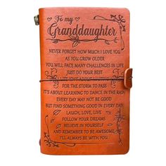 an orange leather notebook with the words granddaughter written on it