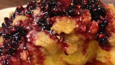 a close up of a plate of food with berries on it and crumbs