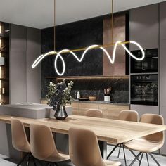 a dining room table with chairs and lights hanging from the ceiling in front of it