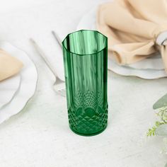 a green glass sitting on top of a table