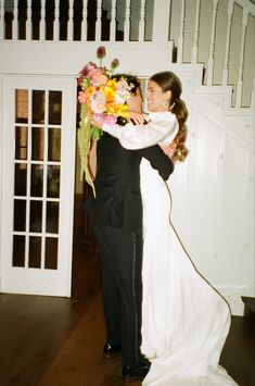 the bride and groom are embracing each other