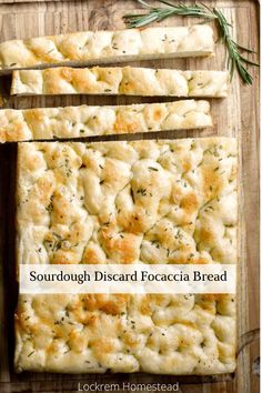 sourdough disard focaccia bread on a cutting board with rosemary sprigs