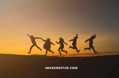 four people jumping in the air at sunset