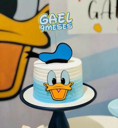 a close up of a cake on a plate with a donald duck decoration in the middle