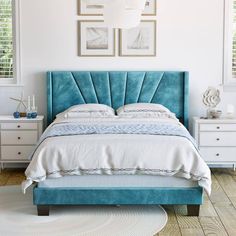 a bed with blue velvet headboard and white linens in a bright bedroom setting