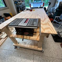 a workbench made out of plywood in a garage with tools on it