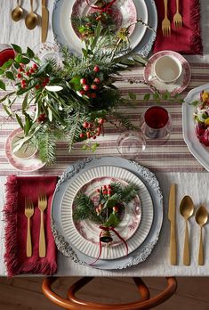 the table is set for christmas dinner with silverware