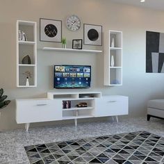 a living room with a couch, television and shelves on the wall in front of it