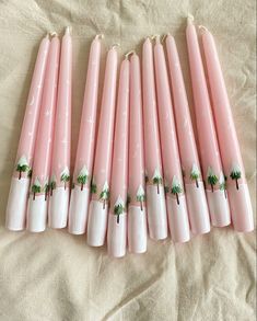 Hand painted pink candles with snow fir trees Advent Pillar Candles, Painted Candle Tapers, Painted Candlesticks Christmas, Christmas Candle Painting Ideas, Christmas Taper Candles, Diy Painted Candles, How To Paint Candles, Candle Painting Ideas, Candle Decoration Ideas