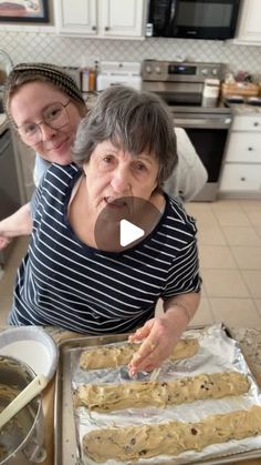 two women in the kitchen making cookies and puddings for dinner or dessert with chocolate chip cookie bars