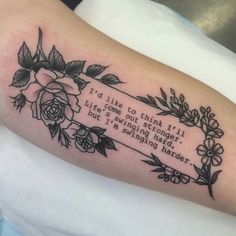 a woman's arm with a quote on it and flowers in the frame that reads i'd like to think ill