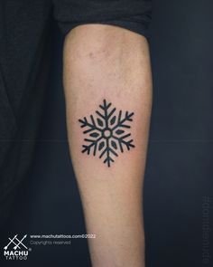 a snowflake tattoo on the arm