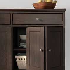 a wooden cabinet with plates and bowls on top