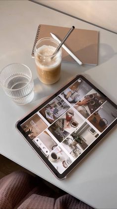 an ipad on a table next to a cup of coffee and a glass with a straw