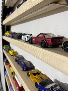 toy cars are lined up on the shelves