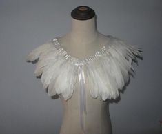 a mannequin with white feathers on it