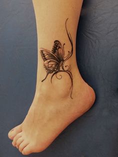 a small butterfly tattoo on the ankle