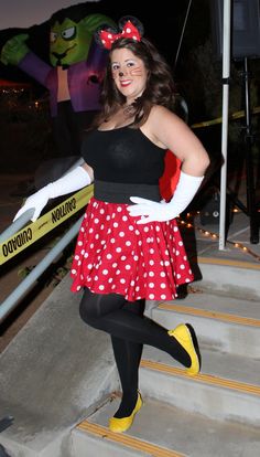 a woman in minnie mouse costume standing on steps