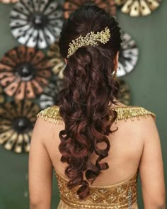 a woman with long hair wearing a gold dress and a tiara on her head