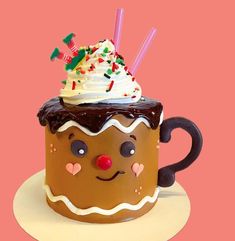 there is a cup cake with whipped cream and chocolate frosting on top, decorated like a gingerbread man