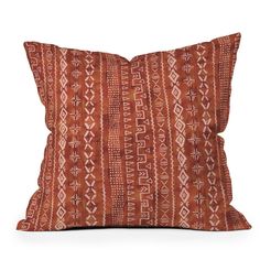 an orange and white pillow on a white background