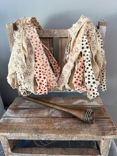 an old baseball bat sitting on top of a wooden bench next to a piece of cloth