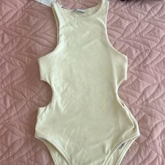 Zara Cream Colored Cutout Bodysuit. Never Worn/ Still Has Tag. Size Large Casual Stretch Bodysuit With Cutout, Chic Sleeveless Bodysuit With Cutout Details, Chic Sleeveless Cutout Bodysuit, Casual Sleeveless Lined One Pieces, White Sleeveless Cutout Bodysuit, Summer Stretch Bodysuit With Cutout, Cream Sleeveless Bodysuit For The Beach, White Cutout Bodysuit For Spring, Spring Beachwear Bodysuit With Cutout