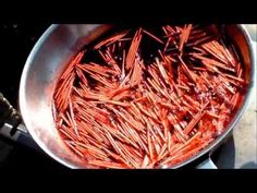 a pan filled with cooked carrots sitting on top of a stove