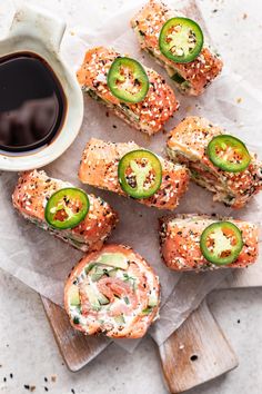 several sushi rolls with cucumbers and sesame seeds on them next to a cup of coffee